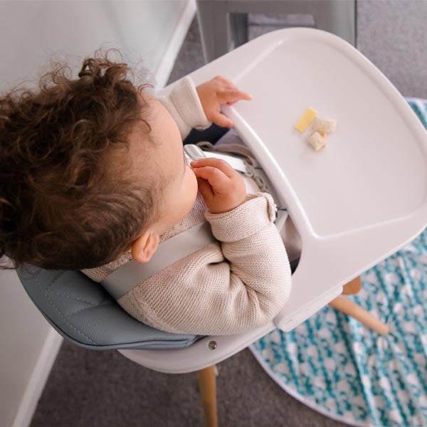baby High Chair with grey padded seat, white removable tray, wooden legs and a secured five-point harness